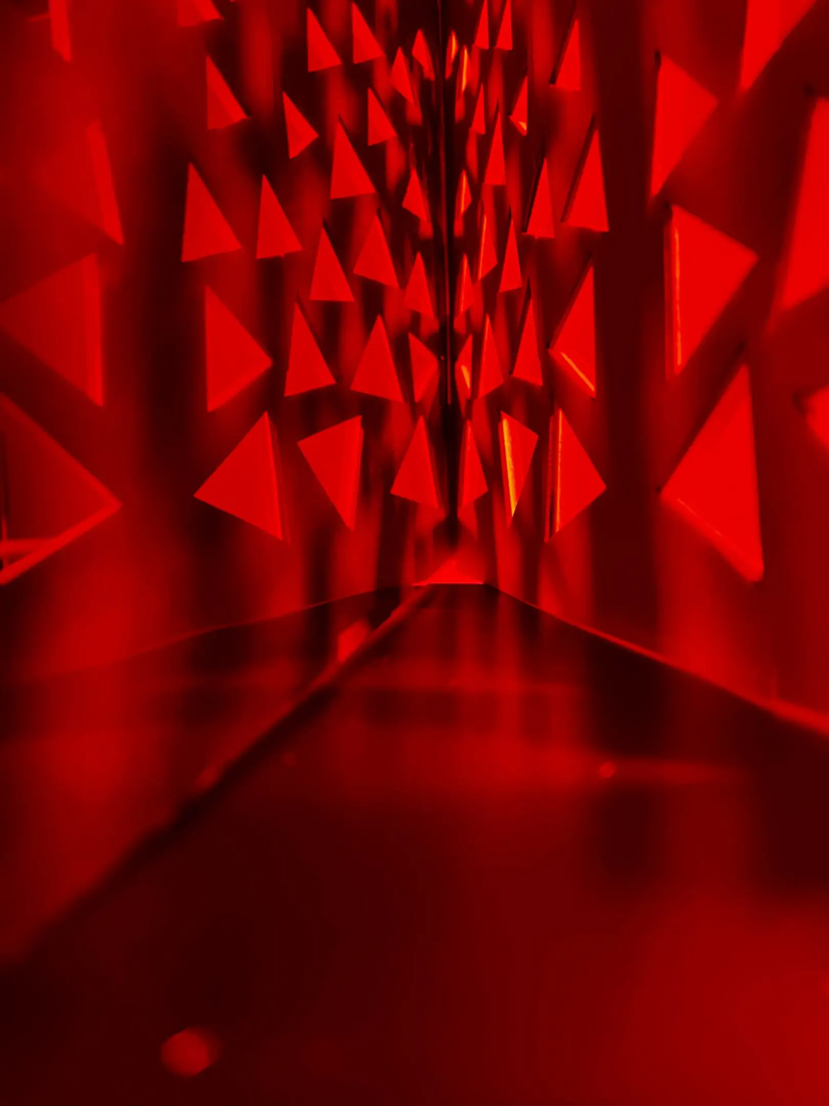 Abstract red triangular light pattern overlaying a document page